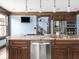 Well-lit kitchen with a large island, granite countertops, stainless steel appliances, and wood trim at 5181 E Pleasant Run Pkwy S Dr, Indianapolis, IN 46219