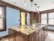 Bright kitchen featuring granite countertops, an island cooktop, and custom wood cabinetry at 5181 E Pleasant Run Pkwy S Dr, Indianapolis, IN 46219