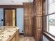 Kitchen featuring wood cabinets, a window, and a partial view of the island at 5181 E Pleasant Run Pkwy S Dr, Indianapolis, IN 46219
