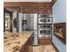 Kitchen with stainless steel appliances, granite countertops, and custom wood cabinetry at 5181 E Pleasant Run Pkwy S Dr, Indianapolis, IN 46219