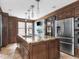 Open kitchen with a large island, granite countertops, stainless steel appliances, and modern lighting at 5181 E Pleasant Run Pkwy S Dr, Indianapolis, IN 46219