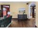Comfortable living room featuring hardwood floors and a stylish accent cabinet at 5181 E Pleasant Run Pkwy S Dr, Indianapolis, IN 46219