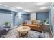Inviting living room with a cozy sofa, stylish decor, and ample seating, creating a perfect space for relaxation at 5181 E Pleasant Run Pkwy S Dr, Indianapolis, IN 46219