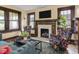 Cozy living room with a fireplace, dark wood trim and comfortable seating at 5181 E Pleasant Run Pkwy S Dr, Indianapolis, IN 46219