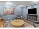 Stylish living room featuring cozy seating, modern artwork, and a round coffee table on a patterned rug at 5181 E Pleasant Run Pkwy S Dr, Indianapolis, IN 46219