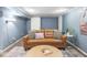 Cozy living room featuring a comfortable sofa, patterned pillows, and a decorative rug, creating a welcoming space at 5181 E Pleasant Run Pkwy S Dr, Indianapolis, IN 46219