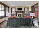 Inviting living room featuring a dark green sofa, fireplace and abundant natural light at 5181 E Pleasant Run Pkwy S Dr, Indianapolis, IN 46219