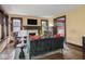 Bright living room with a fireplace, large windows, and patterned accent chairs at 5181 E Pleasant Run Pkwy S Dr, Indianapolis, IN 46219