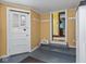 Mudroom with multiple entrances, white cabinetry, and painted blue floors at 5181 E Pleasant Run Pkwy S Dr, Indianapolis, IN 46219