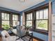 Charming office space with hardwood floors, large windows, and blue walls at 5181 E Pleasant Run Pkwy S Dr, Indianapolis, IN 46219