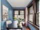 Cozy office featuring blue walls, hardwood floors, natural light, and space for work at 5181 E Pleasant Run Pkwy S Dr, Indianapolis, IN 46219