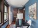Office space with hardwood floors, blue walls, natural light and access to additional rooms at 5181 E Pleasant Run Pkwy S Dr, Indianapolis, IN 46219