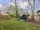 Backyard featuring a wooden playground set with a slide and a swing at 5181 E Pleasant Run Pkwy S Dr, Indianapolis, IN 46219