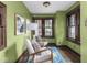 Bright sitting room with large windows, hardwood floors and comfortable seating at 5181 E Pleasant Run Pkwy S Dr, Indianapolis, IN 46219