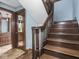 Traditional staircase featuring wooden steps, a railing, and access to other rooms in the home at 5181 E Pleasant Run Pkwy S Dr, Indianapolis, IN 46219