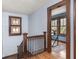 Bright staircase landing with a stained glass window and a view into another room at 5181 E Pleasant Run Pkwy S Dr, Indianapolis, IN 46219