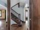 Traditional staircase with stained wood banister and blue accent walls at 5181 E Pleasant Run Pkwy S Dr, Indianapolis, IN 46219