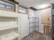 Basement storage area with shelving and exposed utilities, offering ample space for organization and storage solutions at 5181 E Pleasant Run Pkwy S Dr, Indianapolis, IN 46219