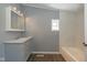 Bathroom features a white vanity and marble sink, with tiled walls above the bathtub at 5515 W Morris St, Indianapolis, IN 46241