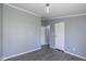 Bedroom featuring grey walls, modern light fixture, and multiple entry and closet doors at 5515 W Morris St, Indianapolis, IN 46241