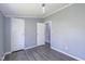 Bedroom featuring grey walls, modern light fixture, and large closets for ample storage at 5515 W Morris St, Indianapolis, IN 46241