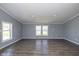 Bright, open living area showcasing neutral walls, wood floors, and large windows at 5515 W Morris St, Indianapolis, IN 46241