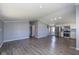 Spacious living area featuring modern gray walls, hardwood flooring, and stainless steel appliances at 5515 W Morris St, Indianapolis, IN 46241