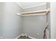 View of the utility room with open shelving, grey walls and washer dryer hookups at 5515 W Morris St, Indianapolis, IN 46241