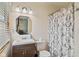 Compact bathroom with a vanity, toilet, and shower featuring a decorative curtain at 57 Hadley St, Mooresville, IN 46158