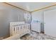 Neutral Bedroom with white crib, changing table, and a gray accent rug at 57 Hadley St, Mooresville, IN 46158