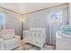This Bedroom features a white crib, comfortable chair, and soft colors, creating a soothing environment at 57 Hadley St, Mooresville, IN 46158