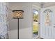 Bright entryway with white door and wall paneling, featuring stylish lamp and decor at 57 Hadley St, Mooresville, IN 46158