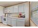Bright kitchen featuring white cabinets, updated appliances, and natural light at 57 Hadley St, Mooresville, IN 46158