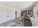 Comfortable living room with gray sectional, hardwood floors, and open doorway to kitchen at 57 Hadley St, Mooresville, IN 46158
