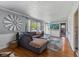 Inviting living room features gray sectional couch, wood floors, and decorative windmill at 57 Hadley St, Mooresville, IN 46158