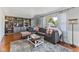 Cozy living room showcasing built-in bookcase, plush gray sofa, and hardwood floors at 57 Hadley St, Mooresville, IN 46158