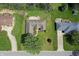 Home with landscaped backyard featuring a patio with fire pit, surrounded by mature trees at 601 Shady Ln, Greenwood, IN 46142