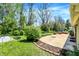 Inviting backyard with a concrete patio, landscaping, and grass, perfect for outdoor enjoyment at 601 Shady Ln, Greenwood, IN 46142