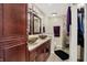 Bathroom featuring double vanity sinks, neutral tile flooring, and a glass-enclosed shower at 601 Shady Ln, Greenwood, IN 46142