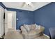 Bedroom featuring comfortable seating, ceiling fan and blue accent wall at 601 Shady Ln, Greenwood, IN 46142