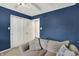 Bedroom featuring double door closet, comfortable seating and blue walls at 601 Shady Ln, Greenwood, IN 46142