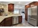 Modern kitchen with stainless steel appliances and stone backsplash at 601 Shady Ln, Greenwood, IN 46142