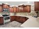 Eat-in kitchen with stone backsplash, stainless steel appliances, and plenty of storage at 601 Shady Ln, Greenwood, IN 46142