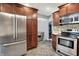 Kitchen with stainless steel appliances, stone backsplash, and plenty of storage at 601 Shady Ln, Greenwood, IN 46142
