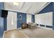 Cozy living room featuring blue walls, vaulted ceilings, and built-in storage at 601 Shady Ln, Greenwood, IN 46142