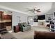 Open-concept living room featuring a fireplace, built-in shelving, and a ceiling fan at 601 Shady Ln, Greenwood, IN 46142