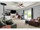 Comfortable living room with a ceiling fan, built-in shelving, and sliding glass doors at 601 Shady Ln, Greenwood, IN 46142
