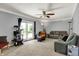 Bright living room featuring a ceiling fan, sliding glass doors, and comfortable seating at 601 Shady Ln, Greenwood, IN 46142