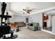 Cozy living room with neutral walls, ceiling fan, and a view into the adjoining kitchen at 601 Shady Ln, Greenwood, IN 46142