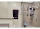 Modern bathroom featuring a tiled shower, neutral walls, and a shower seat at 601 Shady Ln, Greenwood, IN 46142